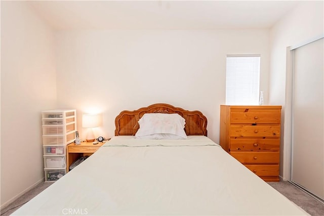 carpeted bedroom with baseboards