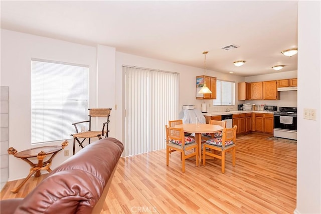 dining space with visible vents and light wood-style floors