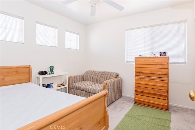 bedroom with baseboards, a ceiling fan, and light carpet