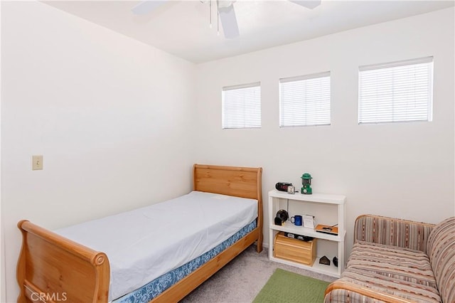 bedroom featuring ceiling fan and carpet