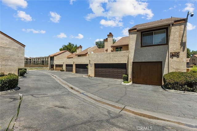 view of street with a residential view and community garages