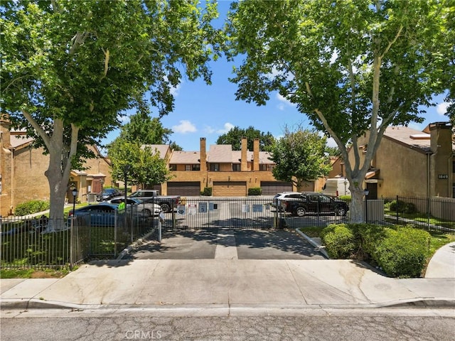 view of property featuring fence private yard, uncovered parking, and a residential view