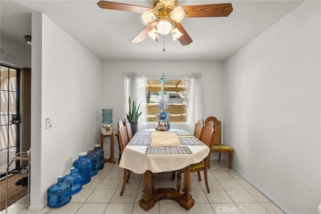 dining room featuring a ceiling fan, light tile patterned floors, and a wealth of natural light