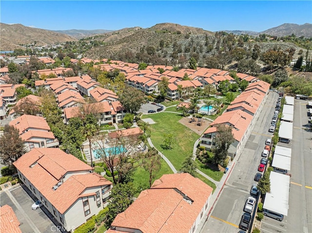 drone / aerial view featuring a residential view and a mountain view