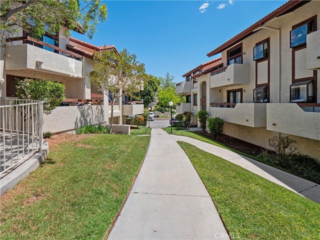view of home's community featuring a yard and a residential view