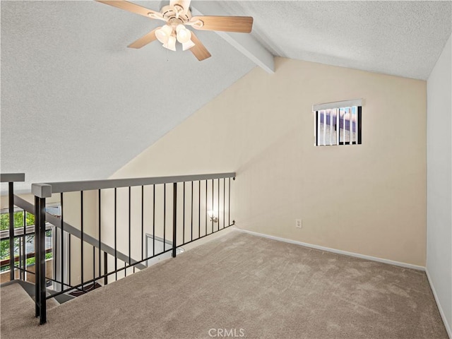 bonus room featuring ceiling fan, a textured ceiling, baseboards, lofted ceiling with beams, and carpet flooring