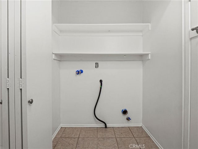 laundry area with baseboards, hookup for a gas dryer, and laundry area