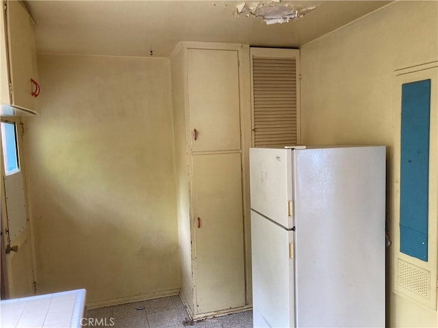 kitchen featuring freestanding refrigerator and tile counters