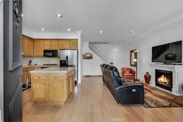 7132 Farralone Ave Unit 203, Canoga Park, CA 91303 - kitchen featuring black microwave, light countertops, stainless steel fridge, and open floor plan