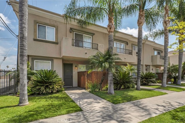 7132 Farralone Ave Unit 203, Canoga Park, CA 91303 - view of front of house featuring stucco siding, a front yard, and fence