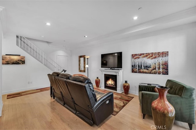 7132 Farralone Ave Unit 203, Canoga Park, CA 91303 - living area with baseboards, a warm lit fireplace, stairway, recessed lighting, and light wood-style flooring