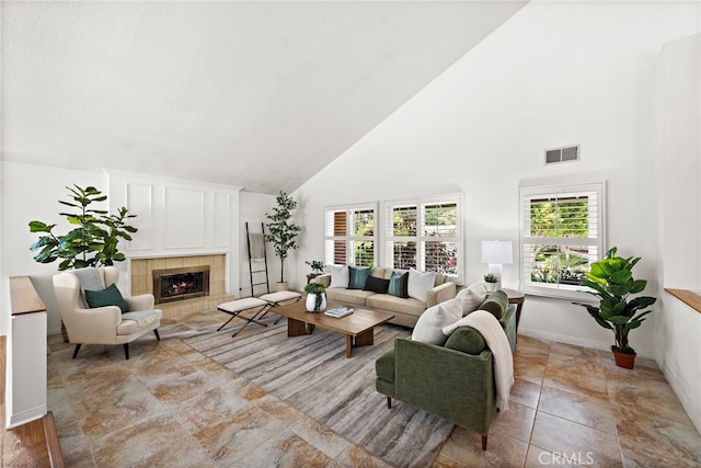 25122 Black Horse Ln, Laguna Hills, CA 92653 - living area featuring a tile fireplace, plenty of natural light, visible vents, and high vaulted ceiling