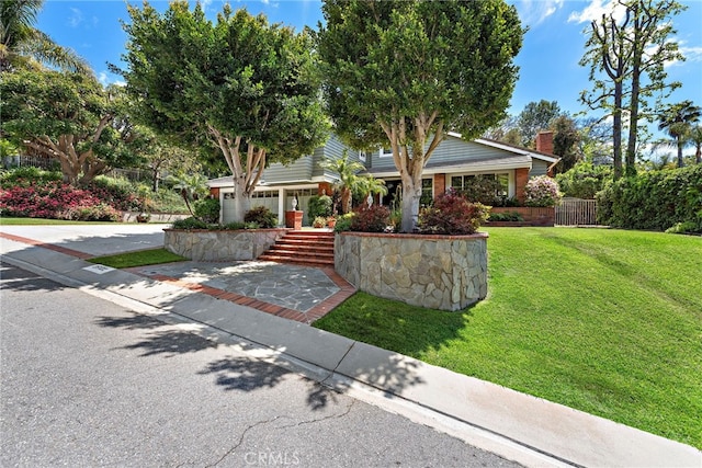 view of property hidden behind natural elements featuring a chimney