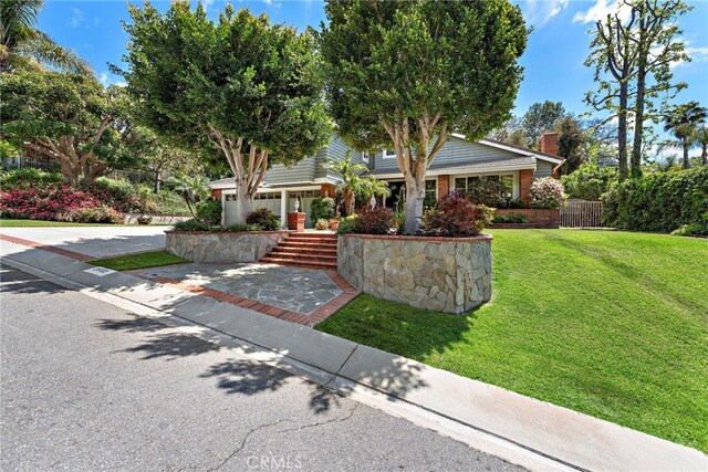 25122 Black Horse Ln, Laguna Hills, CA 92653 - view of property hidden behind natural elements featuring a chimney