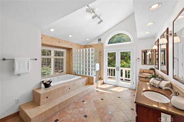 25122 Black Horse Ln, Laguna Hills, CA 92653 - bathroom featuring a sink, vaulted ceiling, french doors, and a bath
