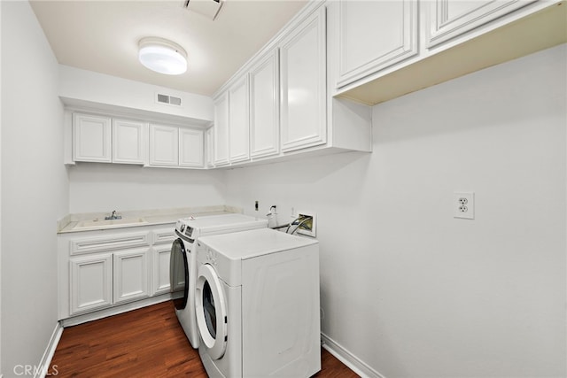 laundry area with washer and dryer, cabinet space, dark wood-type flooring, and baseboards