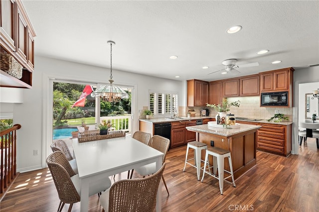 25122 Black Horse Ln, Laguna Hills, CA 92653 - kitchen with a center island, brown cabinetry, dark wood-style flooring, backsplash, and black appliances