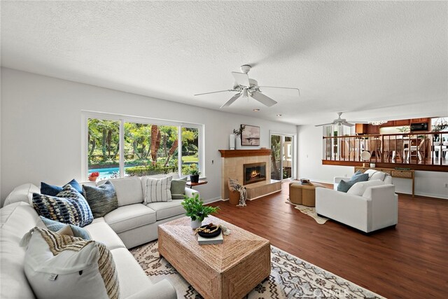 25122 Black Horse Ln, Laguna Hills, CA 92653 - living area with ceiling fan, a wealth of natural light, a tile fireplace, and wood finished floors
