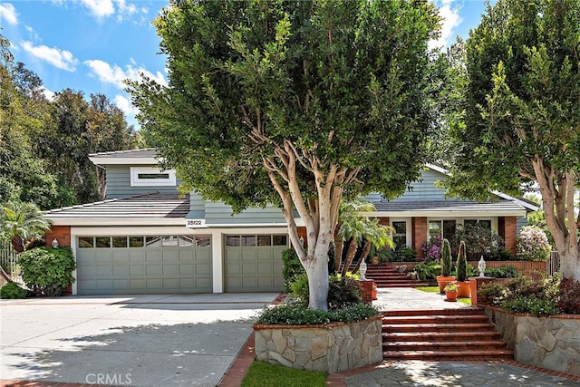 25122 Black Horse Ln, Laguna Hills, CA 92653 - view of front facade with stairway, an attached garage, and driveway