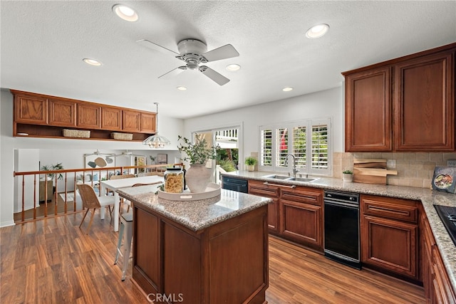 25122 Black Horse Ln, Laguna Hills, CA 92653 - kitchen featuring a ceiling fan, a center island, a sink, decorative backsplash, and dark wood-style floors