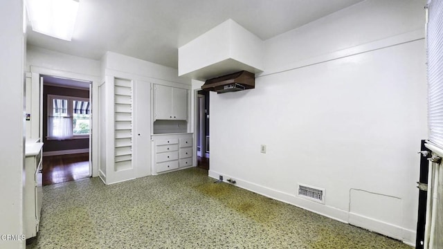 interior space with baseboards and visible vents