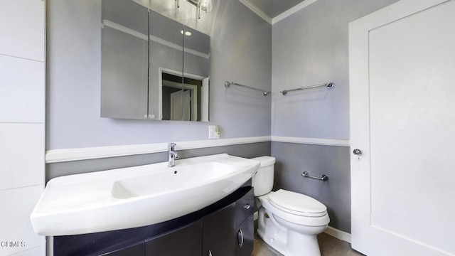 bathroom with crown molding, toilet, and vanity
