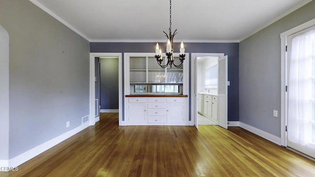 unfurnished dining area with visible vents, baseboards, a chandelier, and dark wood-style floors