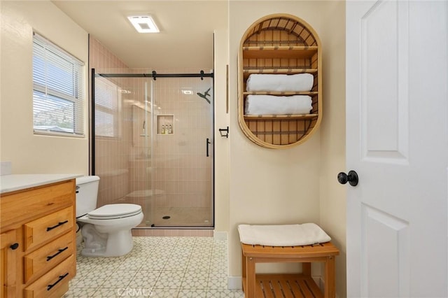 full bath featuring toilet, tile patterned floors, a shower stall, and vanity