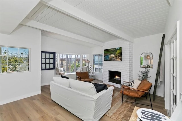 33935 Violet Lantern St, Dana Point, CA 92629 - living room with baseboards, lofted ceiling with beams, light wood finished floors, and a brick fireplace