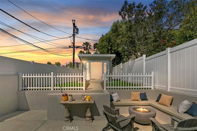 33935 Violet Lantern St, Dana Point, CA 92629 - patio terrace at dusk featuring a fenced backyard and an outdoor fire pit