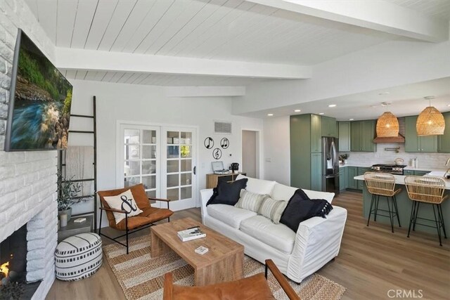33935 Violet Lantern St, Dana Point, CA 92629 - living room featuring lofted ceiling with beams, a fireplace, recessed lighting, wood finished floors, and visible vents