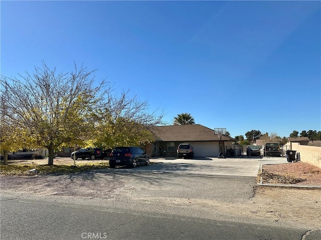 view of front of home with an attached garage and fence