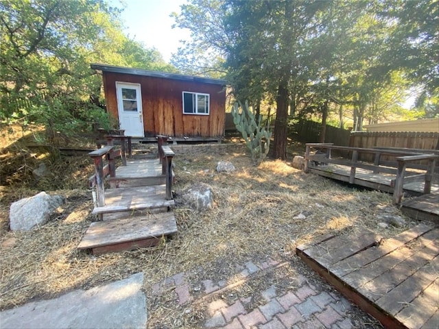 view of yard with fence, an outdoor structure, and a deck