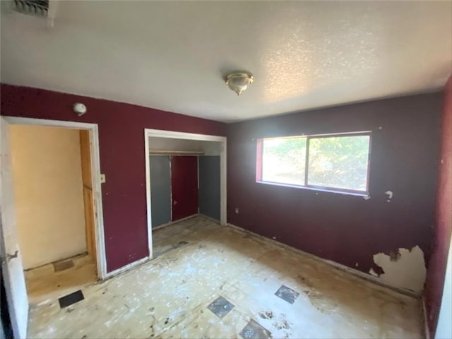 unfurnished bedroom with visible vents and a closet