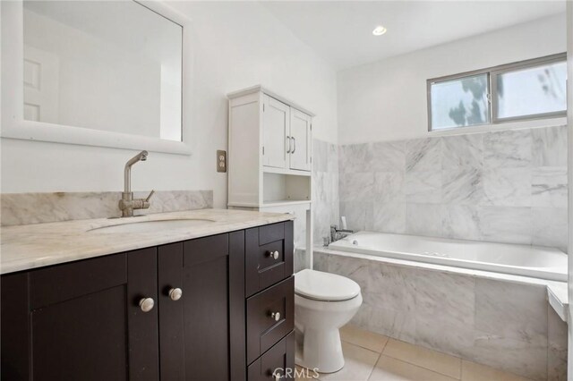 bathroom with a bathtub, tile patterned floors, toilet, and vanity