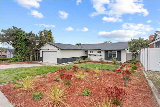 single story home featuring a garage, a front lawn, fence, and concrete driveway