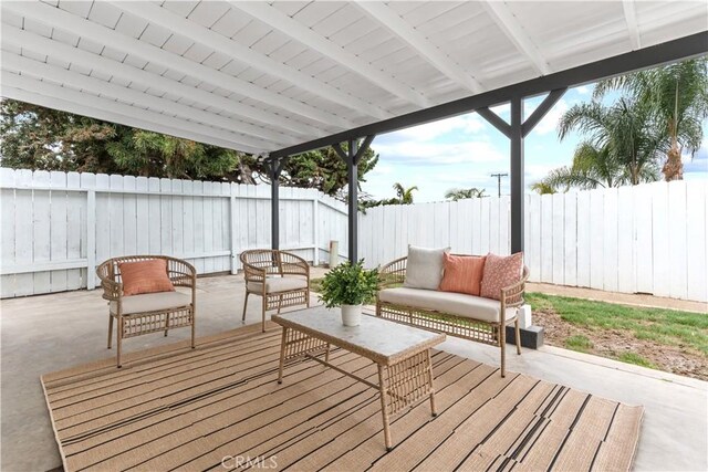 deck featuring an outdoor living space, a fenced backyard, and a patio area