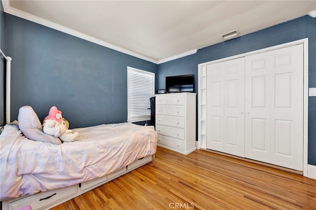 14948 Flomar Dr, Whittier, CA 90603 - bedroom with visible vents, ornamental molding, a closet, and light wood-type flooring