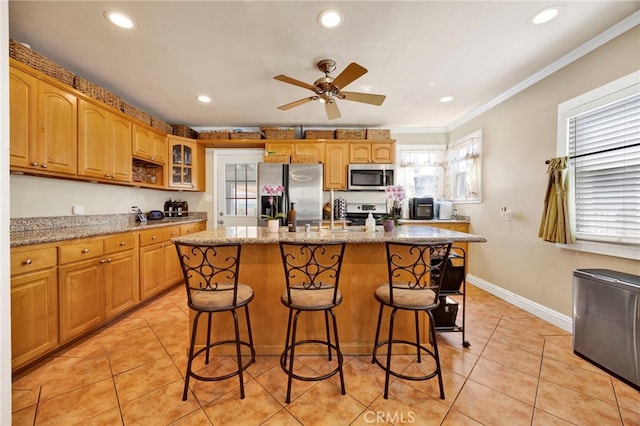14948 Flomar Dr, Whittier, CA 90603 - kitchen featuring crown molding, appliances with stainless steel finishes, glass insert cabinets, a breakfast bar, and recessed lighting