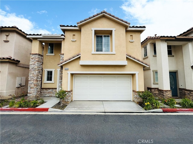 view of front of home with an attached garage, stone siding, stucco siding, concrete driveway, and a tiled roof