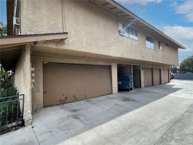 1908 E Coral Ave, Orange, CA 92865 - view of side of property with a garage, stucco siding, and concrete driveway