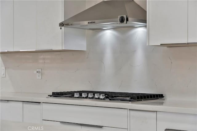 15803 Silvergrove Dr, Whittier, CA 90604 - kitchen featuring decorative backsplash, stainless steel gas cooktop, light countertops, wall chimney exhaust hood, and white cabinetry