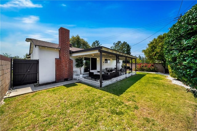15803 Silvergrove Dr, Whittier, CA 90604 - back of property with a fenced backyard, a gate, a chimney, a lawn, and a patio