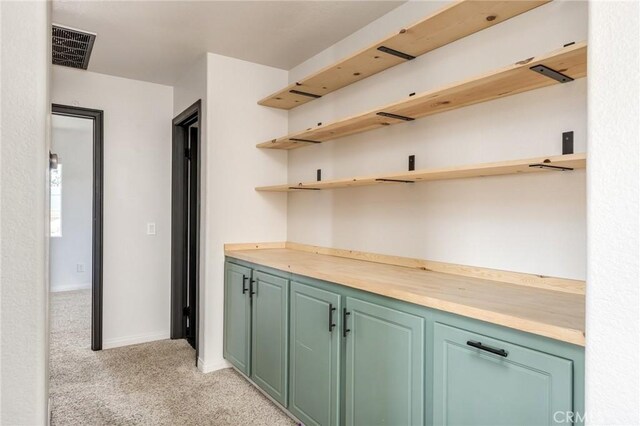 bar with baseboards, light carpet, and visible vents