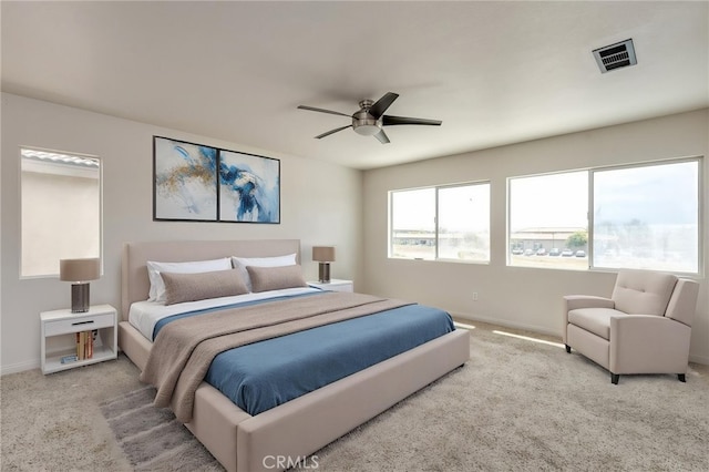 bedroom with baseboards, ceiling fan, carpet, and visible vents