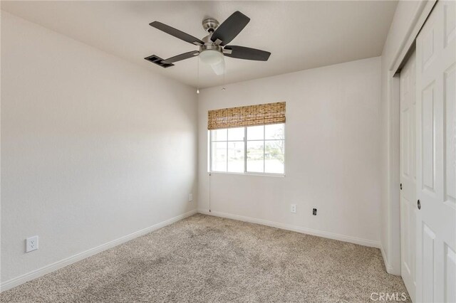 unfurnished bedroom with a closet, baseboards, visible vents, and light carpet