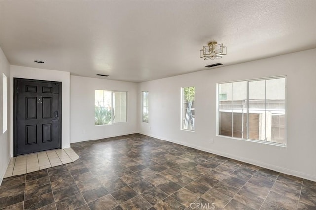 entryway with baseboards, visible vents, and plenty of natural light