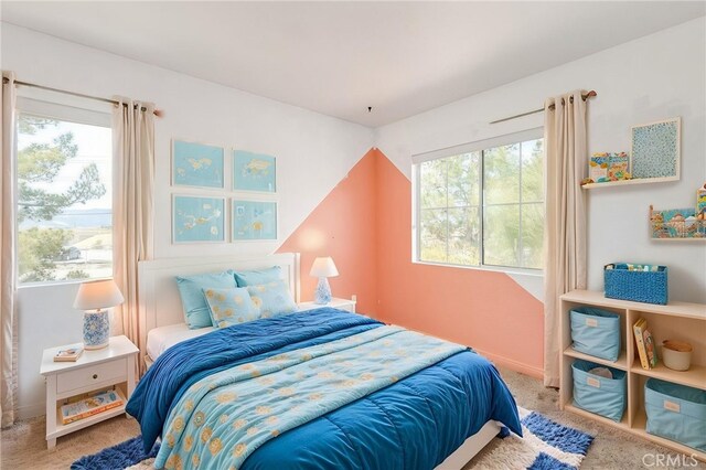 carpeted bedroom featuring baseboards