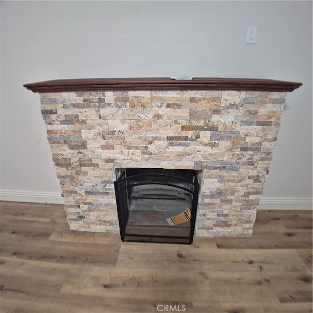804 S Mayo Ave, Compton, CA 90221 - interior details featuring baseboards, a stone fireplace, and wood finished floors