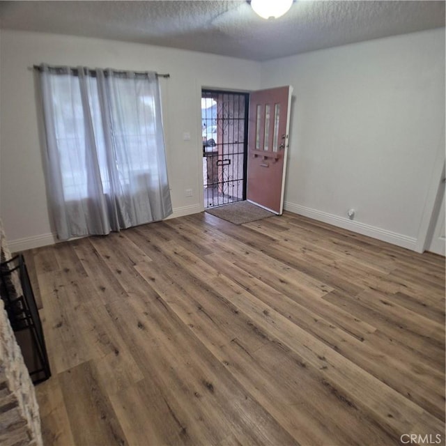 804 S Mayo Ave, Compton, CA 90221 - interior space featuring baseboards, a textured ceiling, and wood finished floors